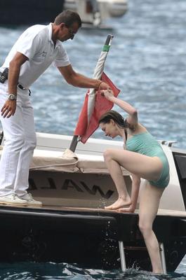 Anne Hathaway poking through her one peice